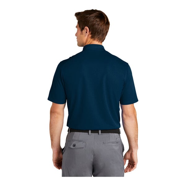 A man wearing a navy Nike Polo shirt.