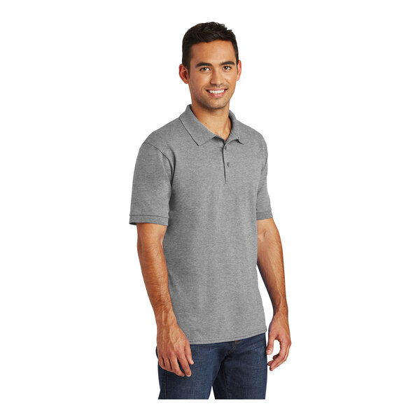 A man wearing a Port & Company athletic heather short sleeve polo shirt.