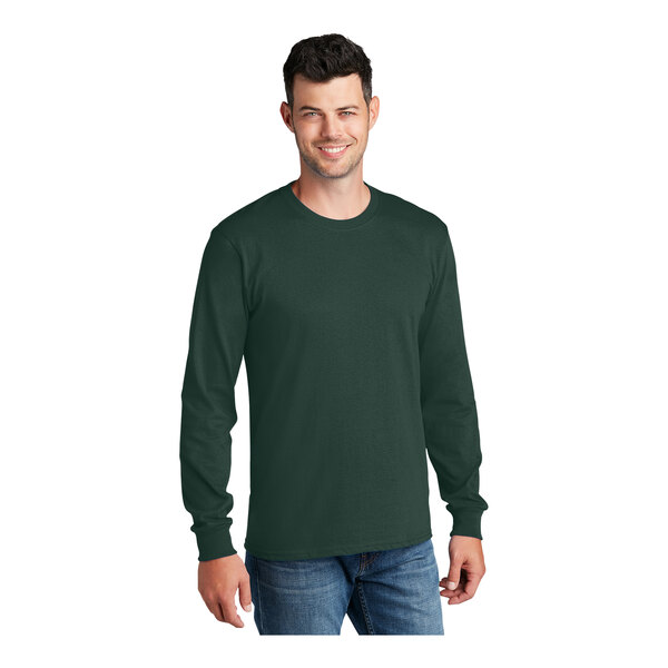 A man wearing a dark green Port & Company long sleeve T-shirt.