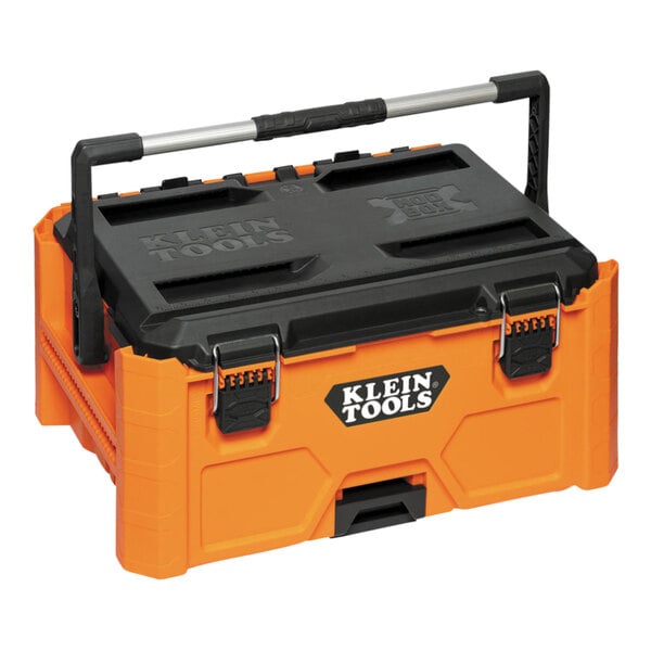 A Klein Tools medium tool box with a black handle on a table.