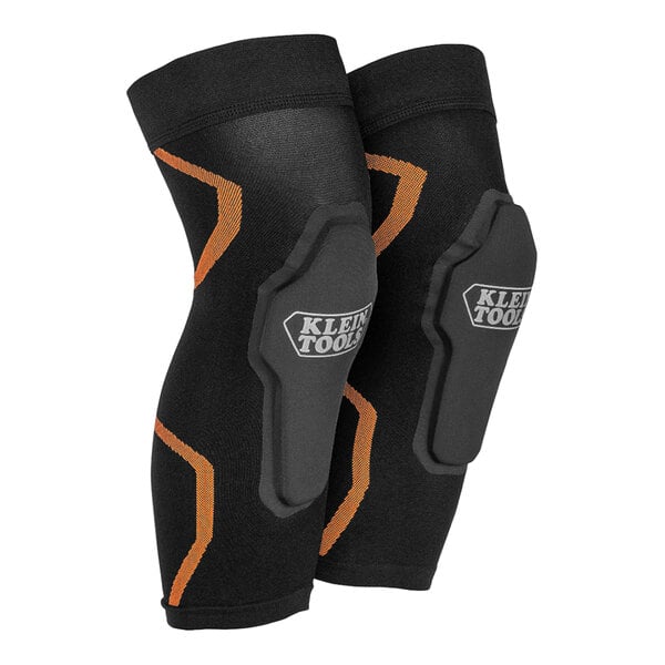 A pair of black knee pads with orange accents.