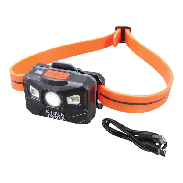 A Klein Tools headlamp with a black and orange strap.