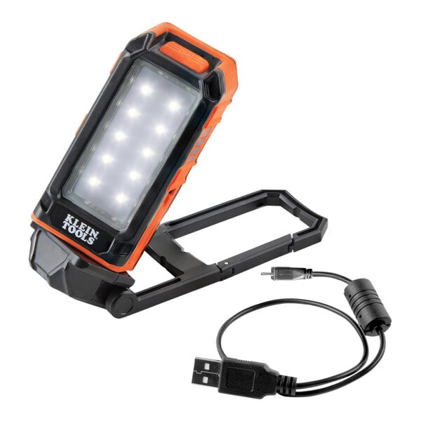 A black and orange Klein Tools LED work light with a black cord.