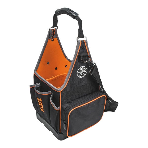 A black and orange Klein Tools Tradesman Pro tool bag with a handle.