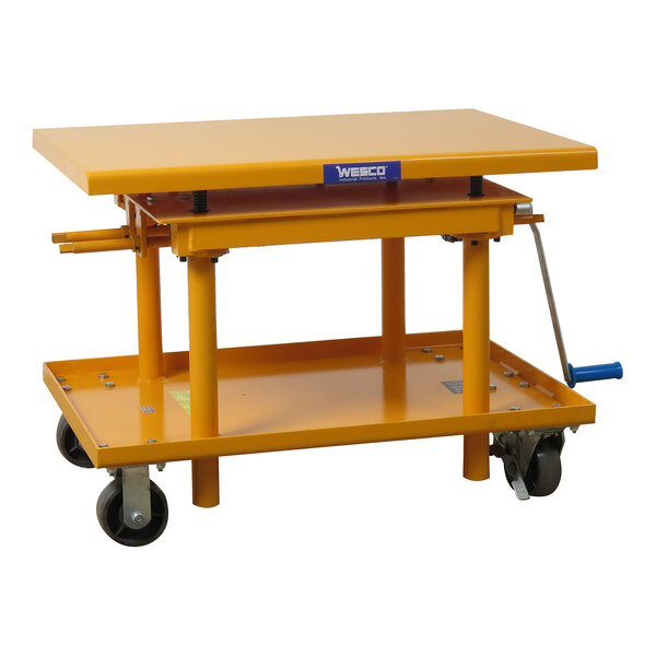 A yellow steel Wesco manual lift table with casters.