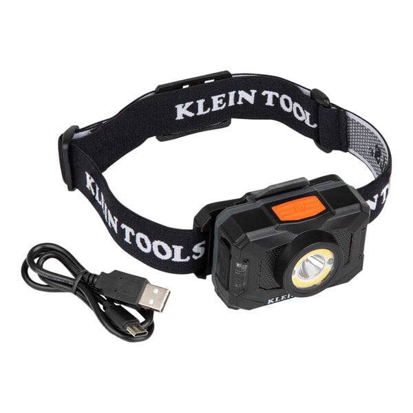 A Klein Tools headlamp with a black fabric strap and a USB cable.