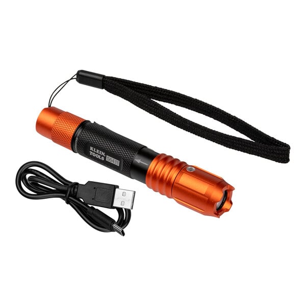 An orange Klein Tools flashlight with a USB cord.