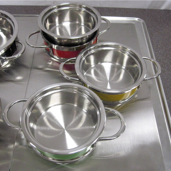 A tray with several stainless steel Bon Chef steam table pots on it.