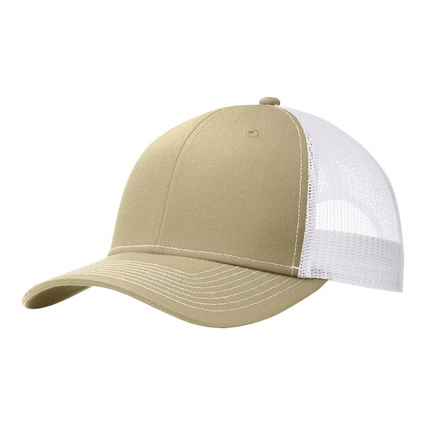 A close-up of a tan and white Port Authority trucker cap with mesh back.