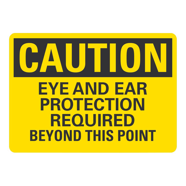 A yellow Lavex safety label with black text reading "Caution Eye And Ear Protection Required Beyond This Point"