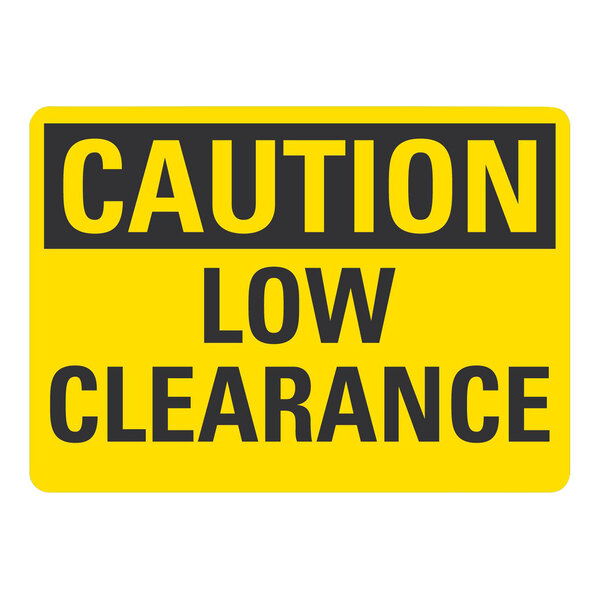 A yellow Lavex plastic "Caution / Low Clearance" sign with black text on a white background.