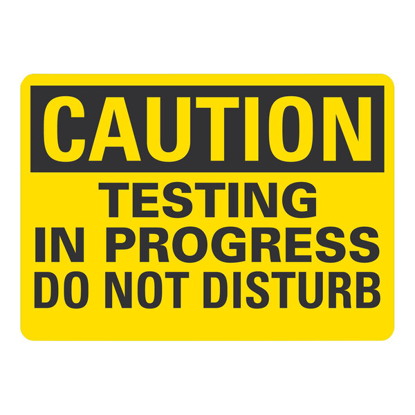 A yellow and black Lavex aluminum safety sign that says "Caution / Testing In Progress / Do Not Disturb"