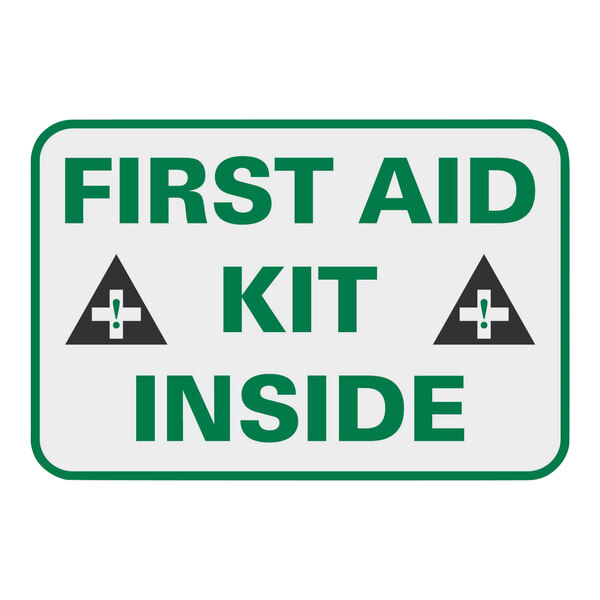 A white sign with green text that says "First Aid Kit Inside"