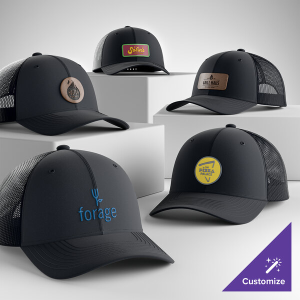 A collection of customizable rich navy 6-panel trucker caps with mesh backs, featuring various logo designs on the front.