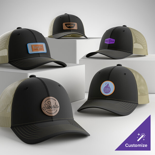 A collection of customizable black and tan 6-panel trucker caps with mesh backs and various logo patches displayed on the front.