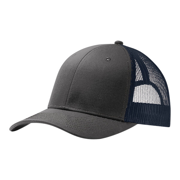 A grey and navy Port Authority trucker cap with a mesh back and white text.
