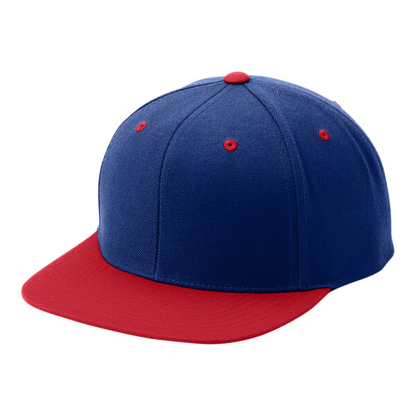 A close-up of a blue and red Sport-Tek baseball cap.