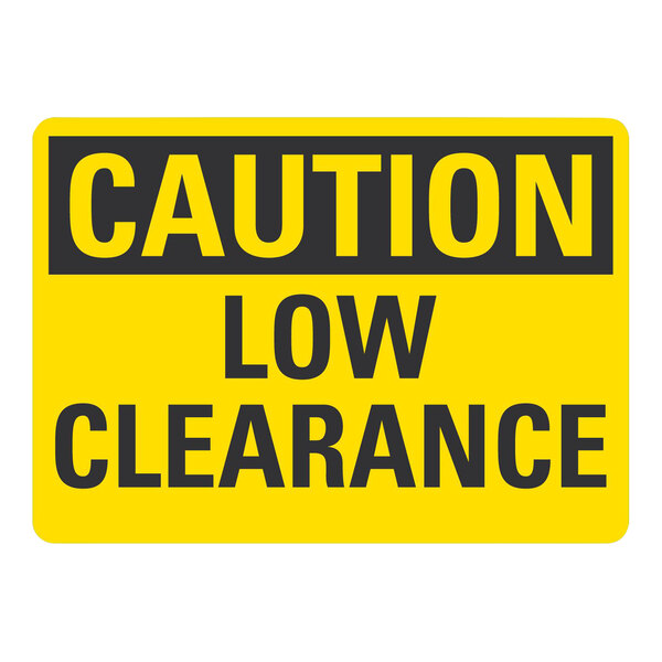 A white rectangular adhesive vinyl safety label with black text reading "Caution / Low Clearance" 