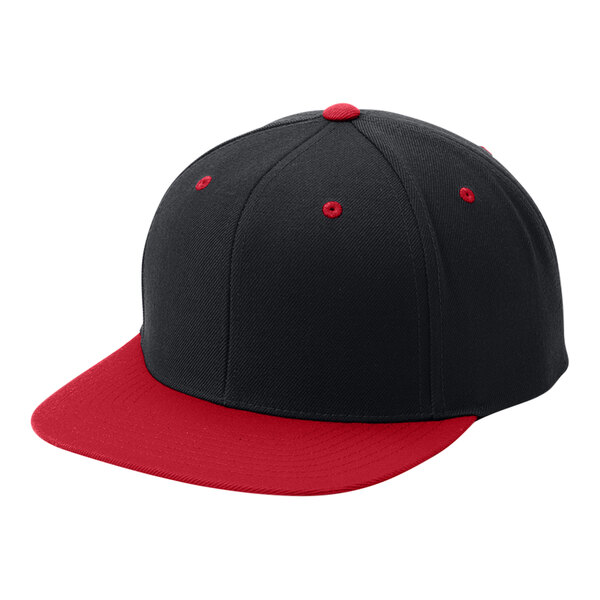 A close up of a black and red Sport-Tek baseball cap with a red brim.