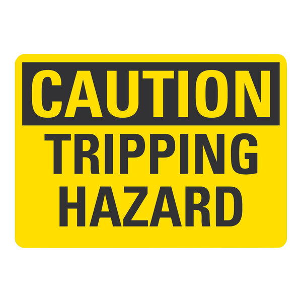 A yellow and black Lavex adhesive vinyl safety label with black text that says "Caution / Tripping Hazard"