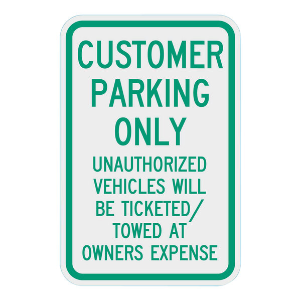 A white rectangular sign with a green border and green text that says "Customer Parking Only" with additional text.