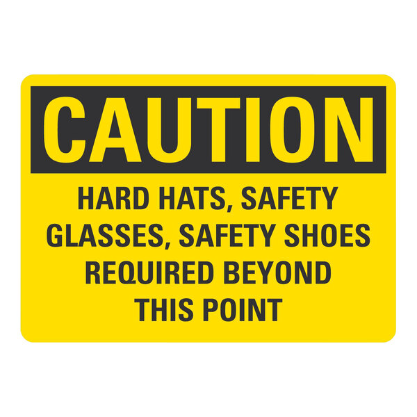 A yellow and black Lavex Safety Label with the text "Caution Hard Hats, Safety Glasses Required Beyond This Point"