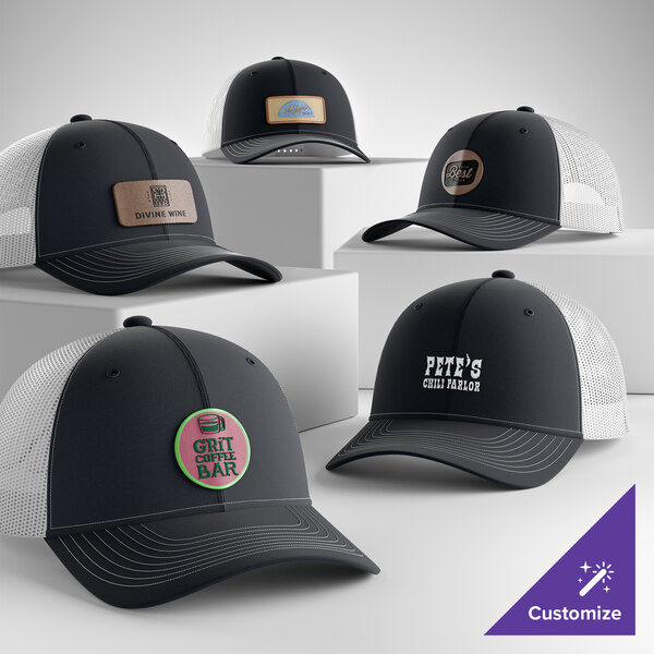 A collection of customizable navy and white 6-panel trucker caps with mesh backs, each featuring different logo designs on the front.