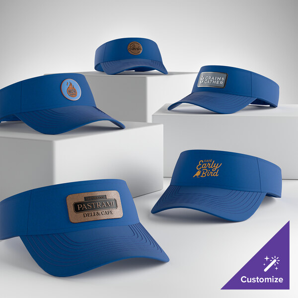 A collection of royal blue customizable visors displayed on white blocks.