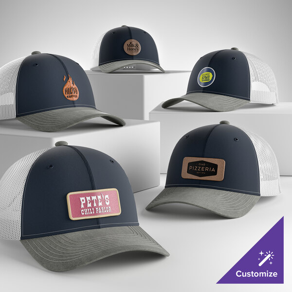 A collection of customizable navy, grey, and white 6-panel trucker caps with mesh backs and various business logos on the front.