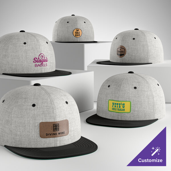A collection of customizable heather grey and black 6-panel flat bill snapback caps with various business logos on the front.