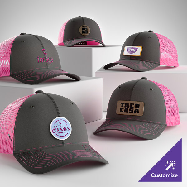 A collection of customizable grey and neon pink 6-panel trucker caps with mesh backs, featuring various logo designs.