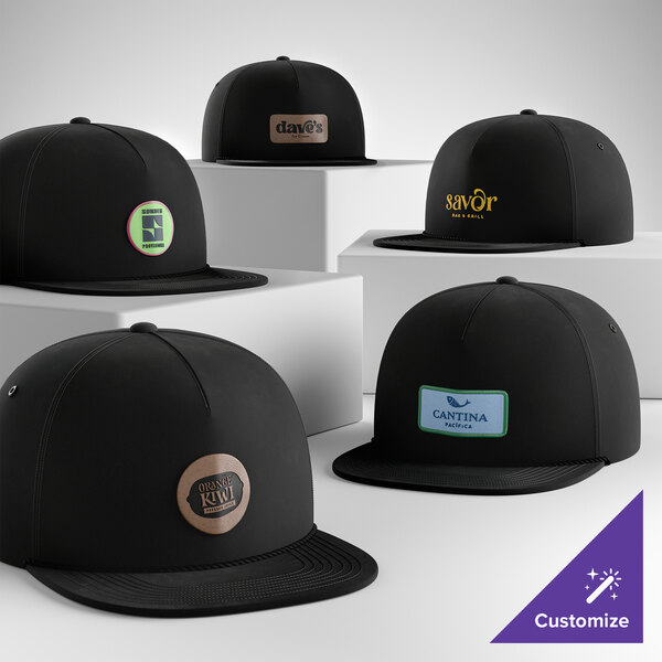 A collection of black 5-panel camper caps with rope detail, each featuring a different customizable logo on the front.