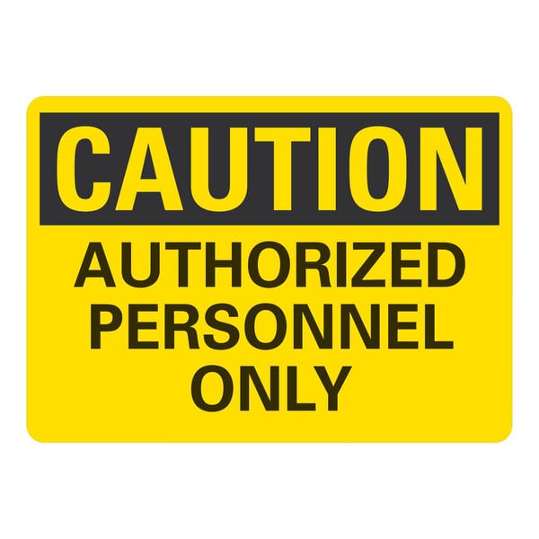 A yellow sign with black text that reads "Caution / Authorized Personnel Only" over a white background.