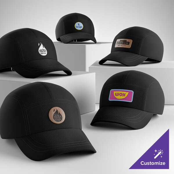 A collection of customizable black 5-panel mesh athletic caps with various logo patches displayed on white platforms.