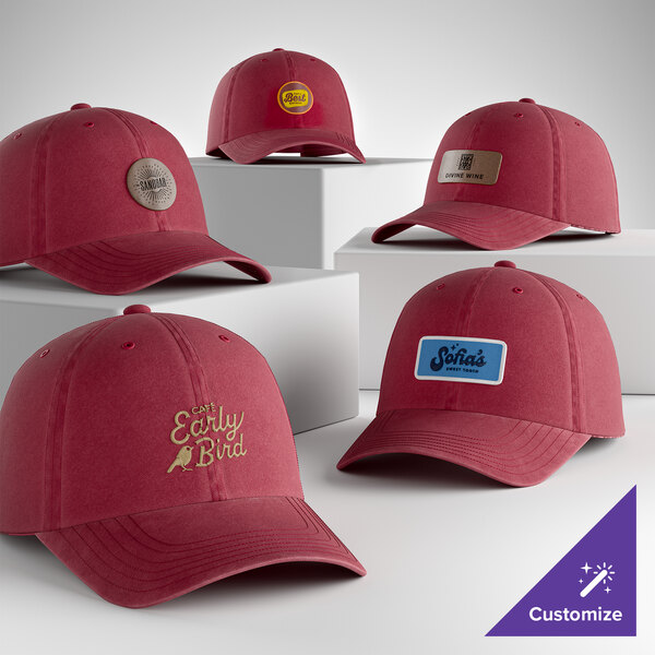 A collection of customizable berry-colored, unstructured, low-profile 6-panel dad caps displayed on white platforms.