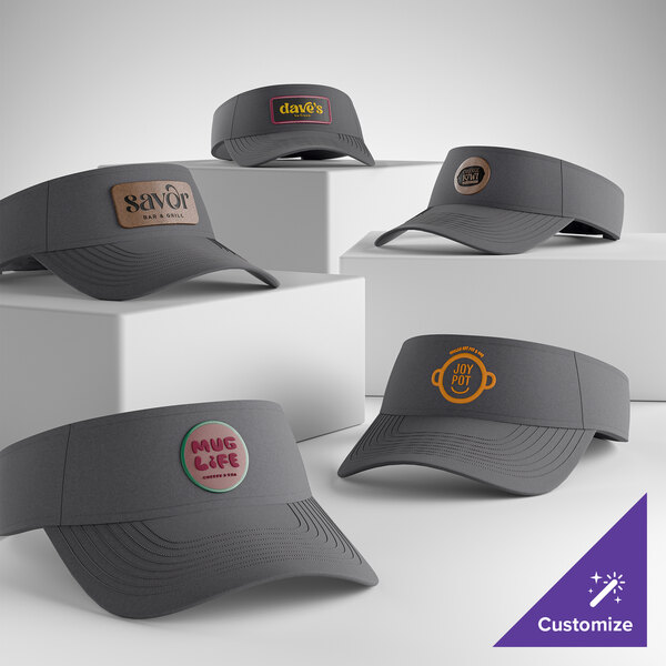 A collection of customizable charcoal visors with various logo designs displayed on the front.