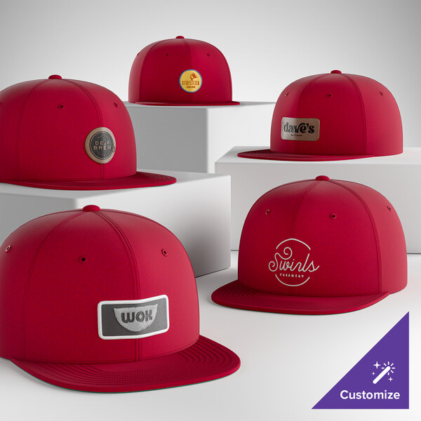 A collection of deep red, structured, high-profile, 6-panel flat bill snapback caps with customizable front patches.