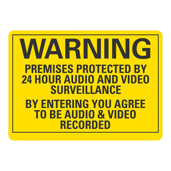 A yellow Lavex sign with black text that says "Premises Protected By 24 Hour Audio And Video Surveillance"