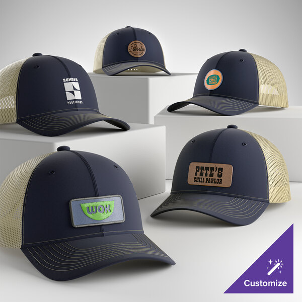 A collection of customizable navy and khaki 6-panel trucker caps with mesh backs, featuring various logo patches on the front.