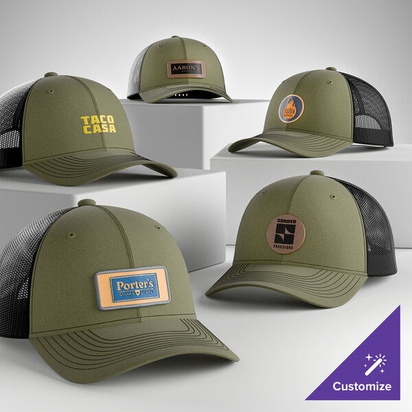 A collection of olive drab green and black mesh trucker caps with customizable front panels displaying various logos and text.
