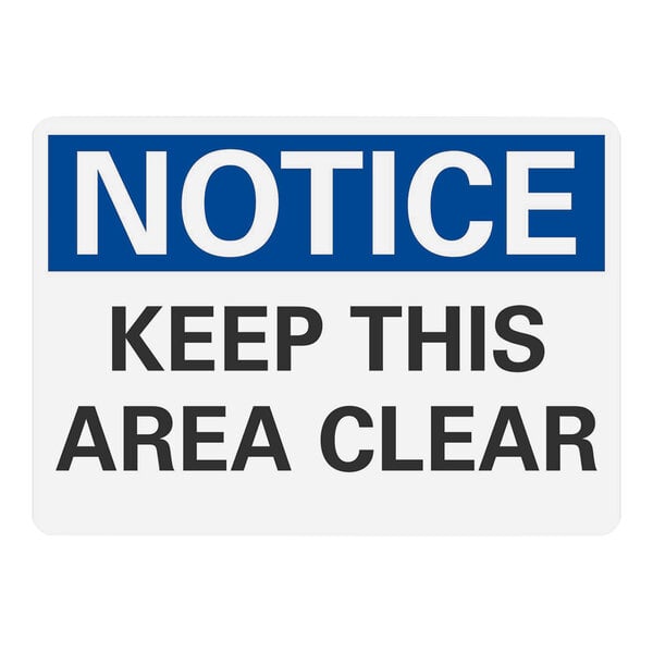 A white and blue Lavex plastic warehouse sign that says "Notice / Keep This Area Clear" in white letters.