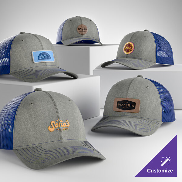 A customizable heather grey and patriot blue 6-panel trucker cap with a mesh back and structured, mid-profile design.