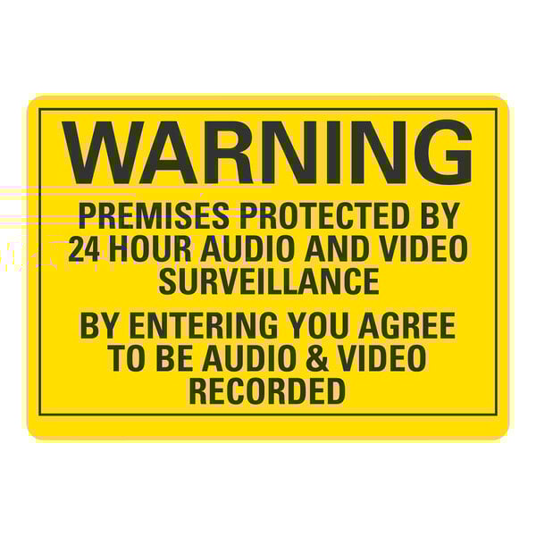 A yellow sign with black text that says "Premises Protected By 24 Hour Audio And Video Surveillance"