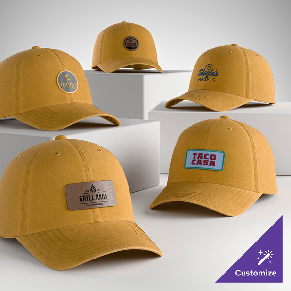 A collection of customizable dandelion yellow 6-panel garment-washed dad caps with various logo patches on the front.