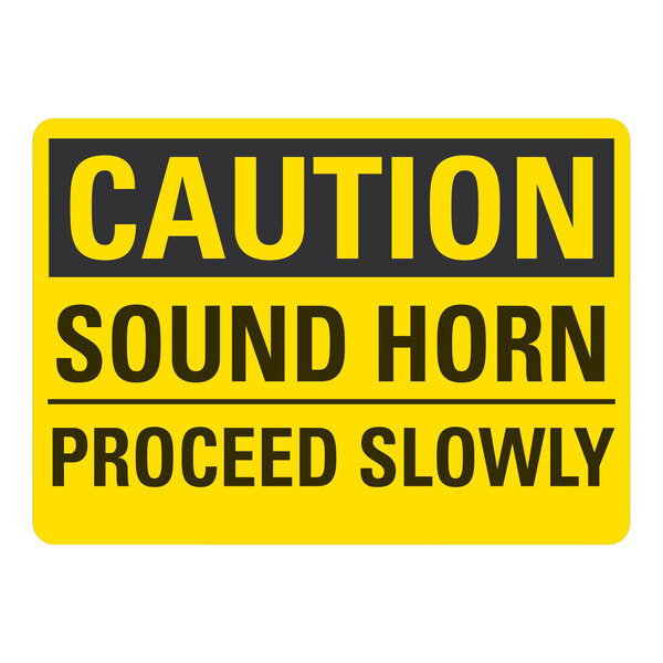 A yellow and black Lavex adhesive vinyl safety label with black text reading "Caution Sound Horn Proceed Slowly"