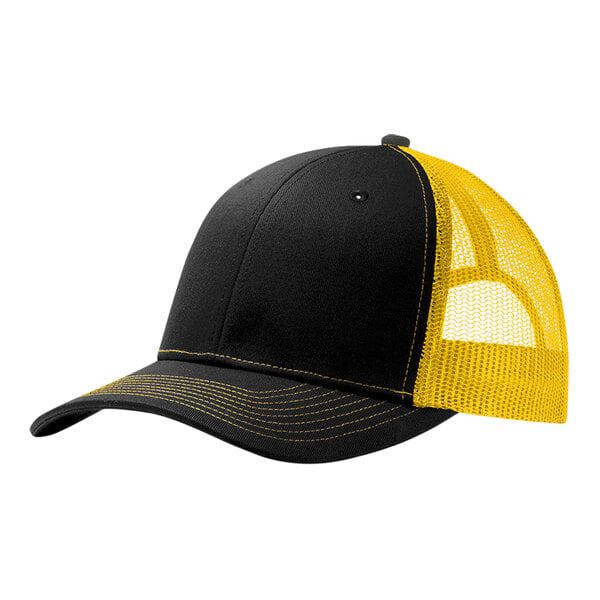 A black and gold Port Authority trucker cap with a mesh back and front.