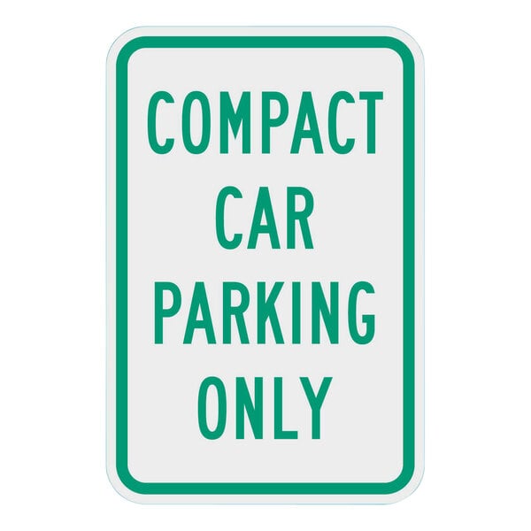 A white and green rectangular sign with text that says "Compact Car Parking Only" in green.