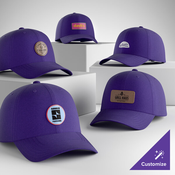 A collection of customizable purple 6-panel dad caps with various logo patches displayed on a white background.