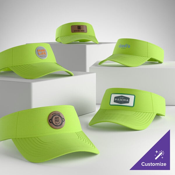 A collection of customizable green oasis visors displayed on white blocks.