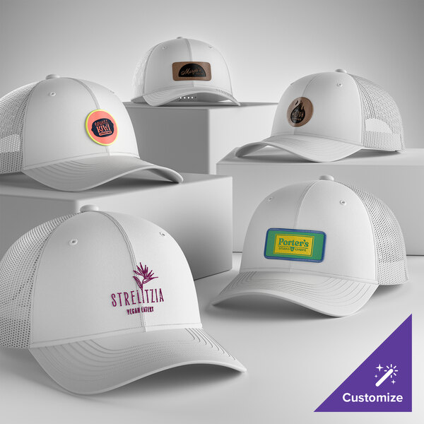 A collection of customizable white 6-panel trucker caps with mesh backs and various logo designs displayed on the front.